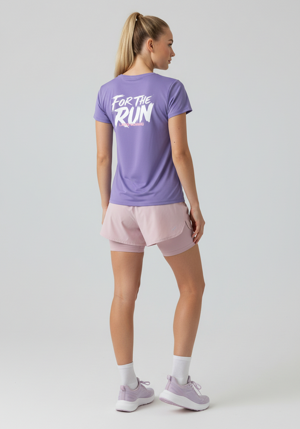 Back view of women’s lavender Layer FTR Graphic Run Tee showing white “For The Run” graphic on upper back