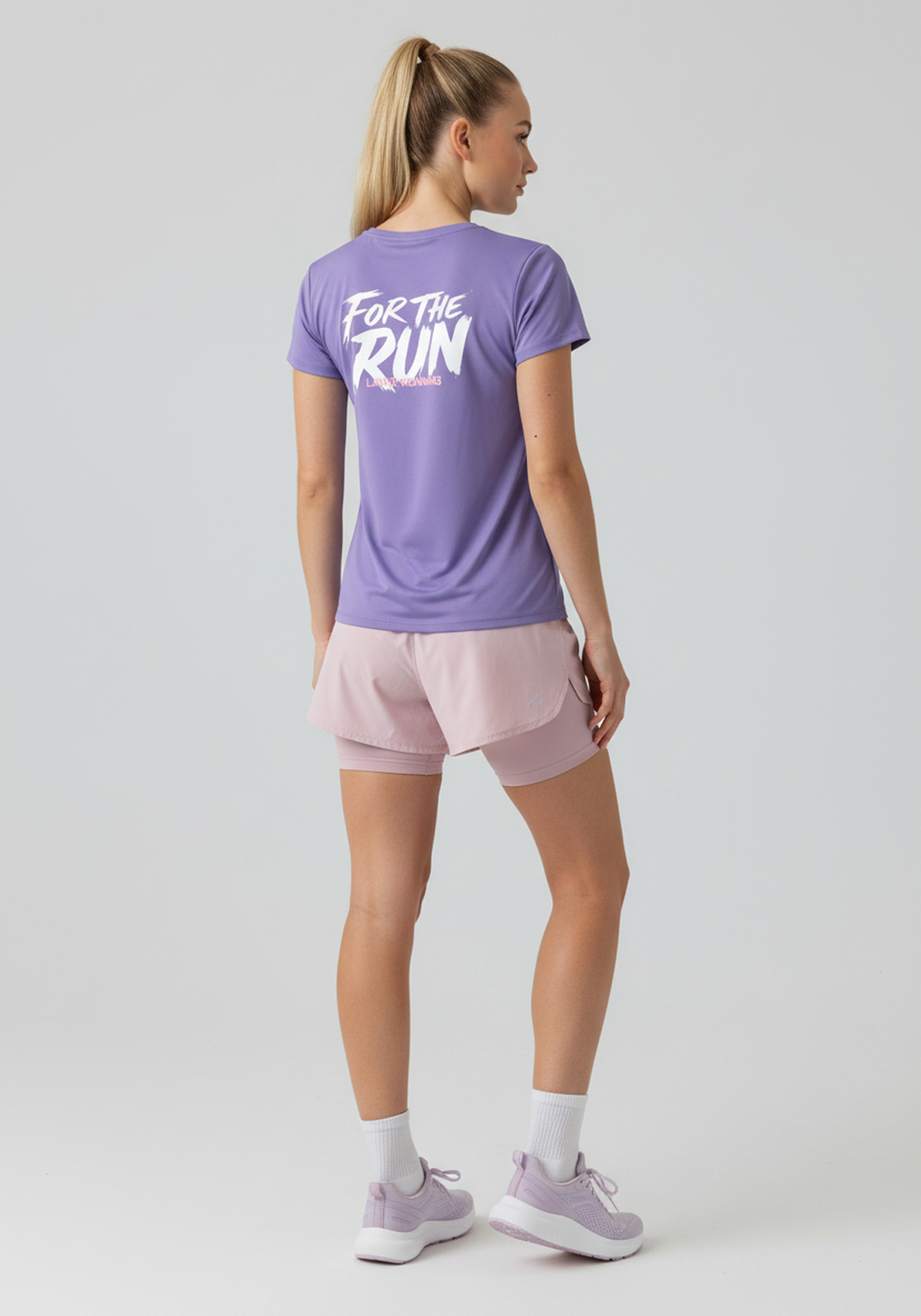 Back view of women’s lavender Layer FTR Graphic Run Tee showing white “For The Run” graphic on upper back