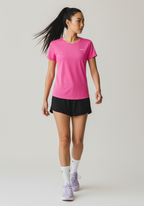 Side angle of woman in pink Layer Women’s FTR Graphic Running Tee during movement, showing lightweight athletic fit.