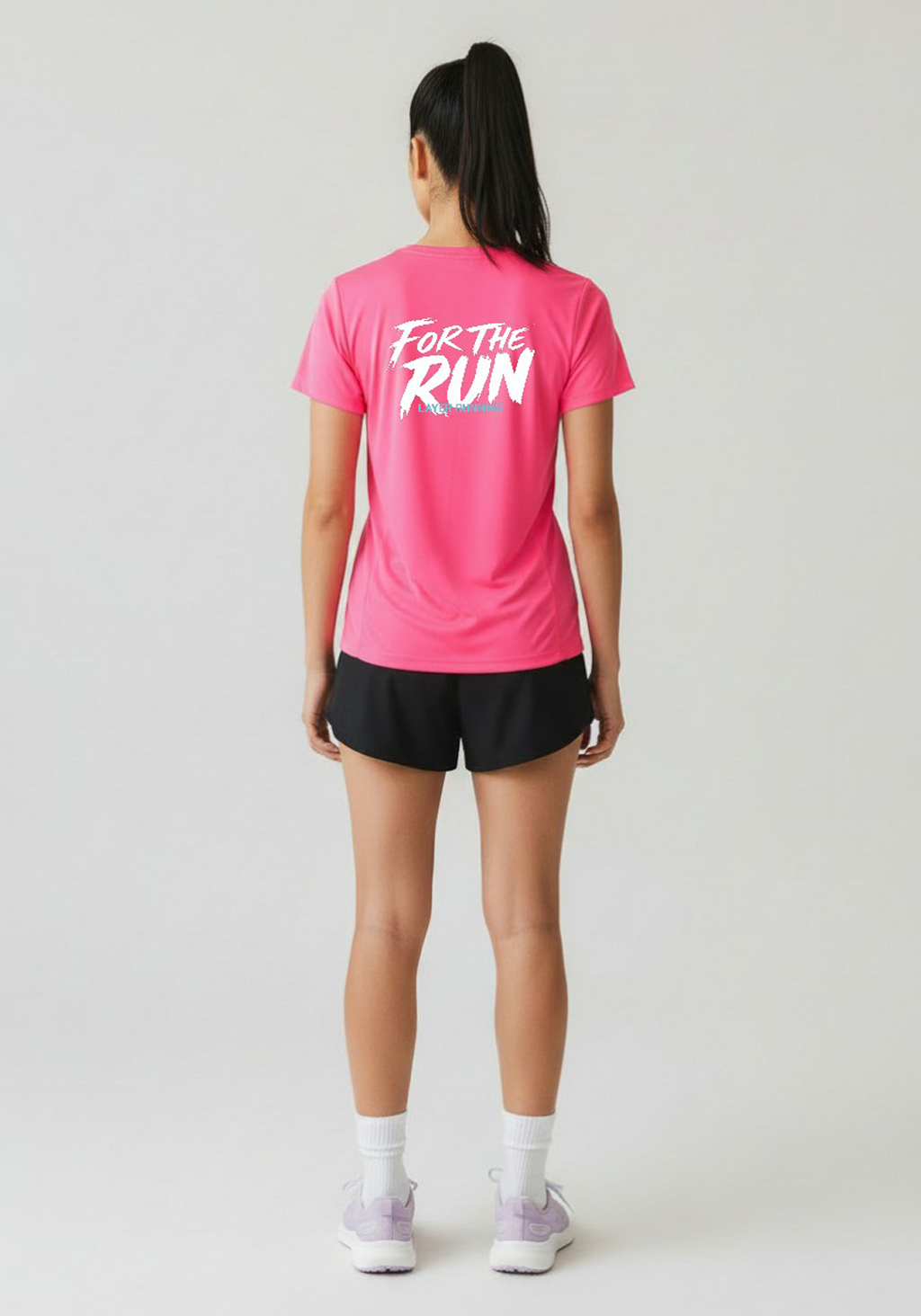 Rear view of pink Layer Women’s FTR Graphic Running Tee featuring bold ‘For The Run’ graphic across the back.