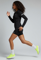 Layer Women’s For The Run Long Sleeve Tee in black – on-model side running view showing dynamic movement and flexible design