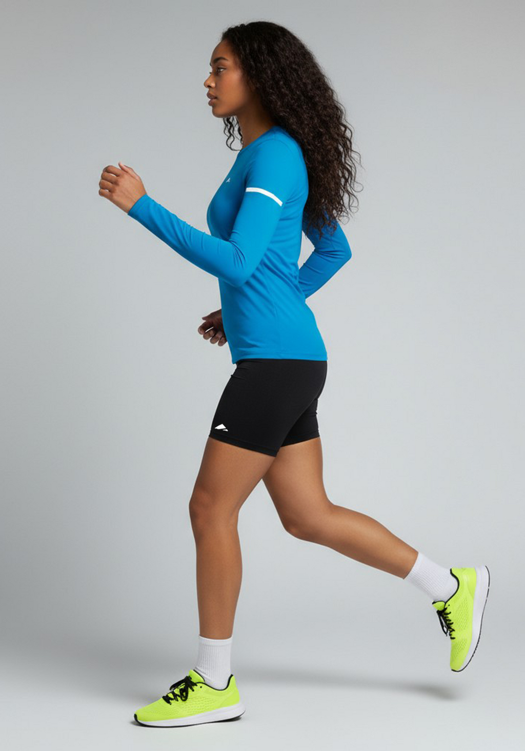 Layer Women’s For The Run Long Sleeve Tee in sapphire – on-model side running view showing movement and breathable comfort