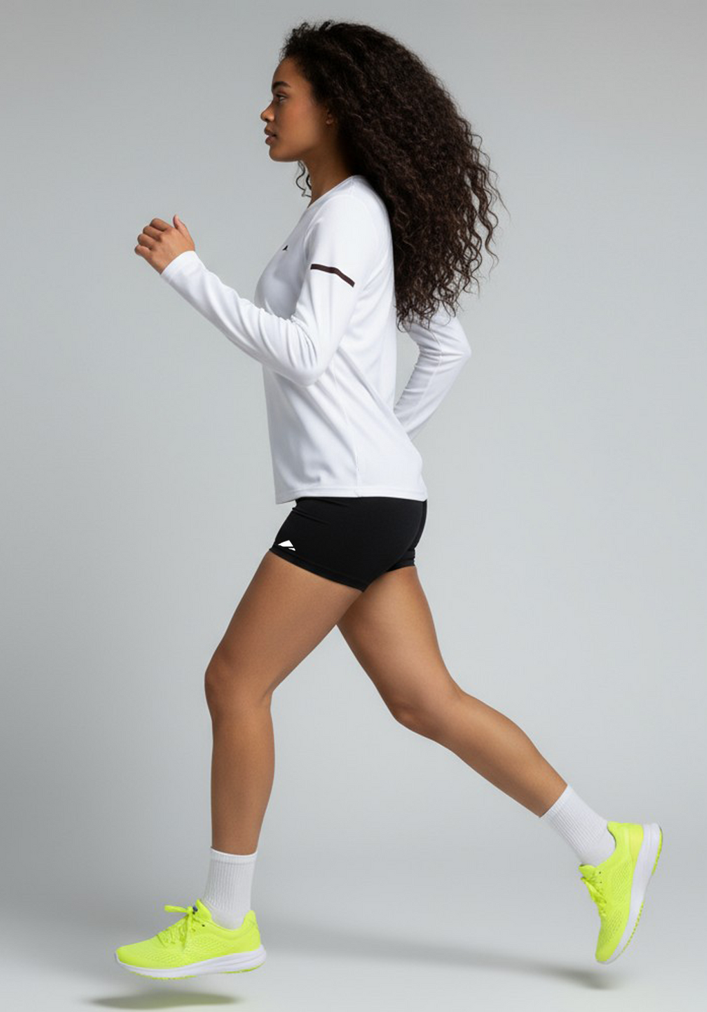 Layer Women’s For The Run Long Sleeve Tee in white – on-model side running view showing natural motion and athletic comfort