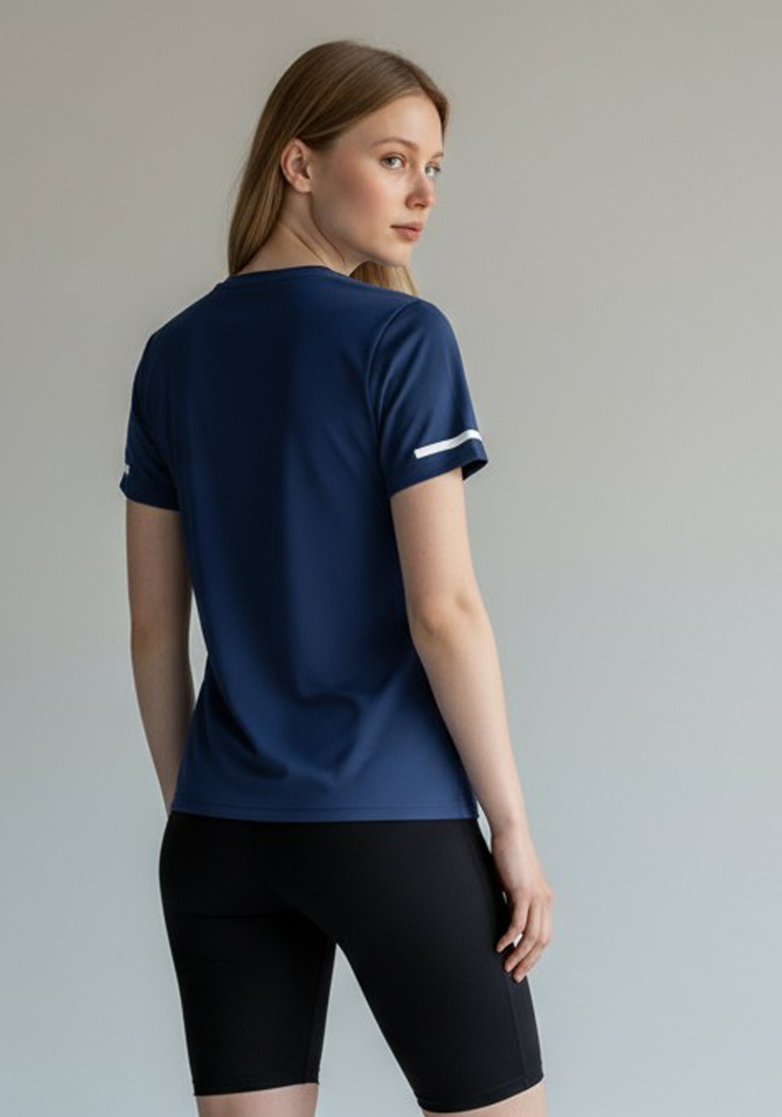 Layer Women’s For The Run Tee in navy – close-up back view showing stretch texture and premium finish