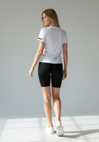 Layer Women’s For The Run Tee in white – on-model back view showing curved seam lines and soft stretch design